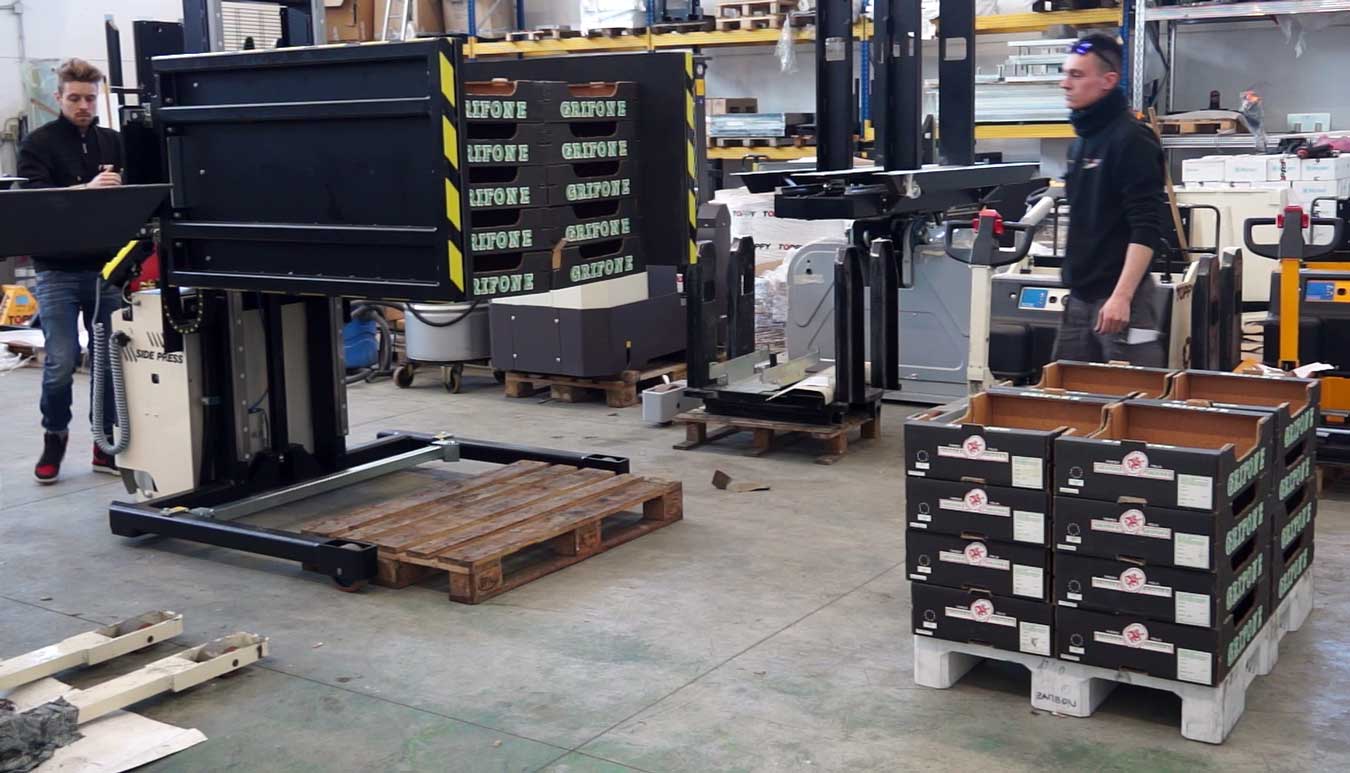 Robotic arm selecting layers of product from pallet