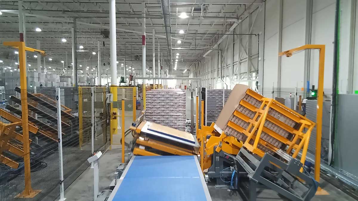 Image of Automated Pallet Transfer System with Robotic Arms and Conveyor Belts