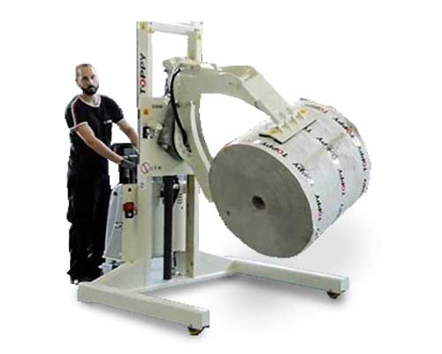 An image of Roll Turners in a manufacturing facility, used to rotate rolls of material for easy handling and transportation