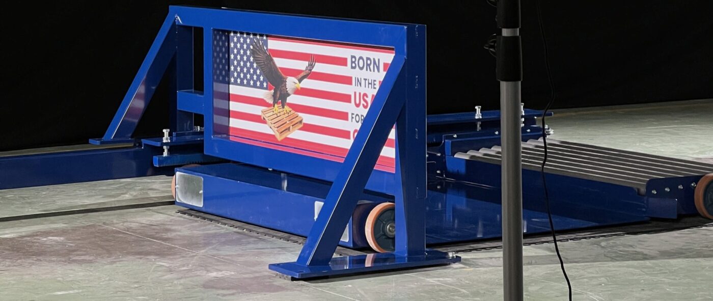 Pallet changer machine made in the USA with industrial structure and American flag branding